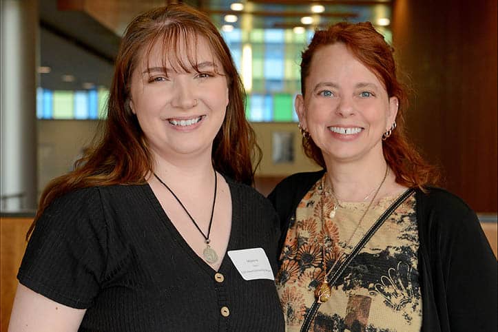 FLCC alumni and faculty standing together, volunteering at a college event.