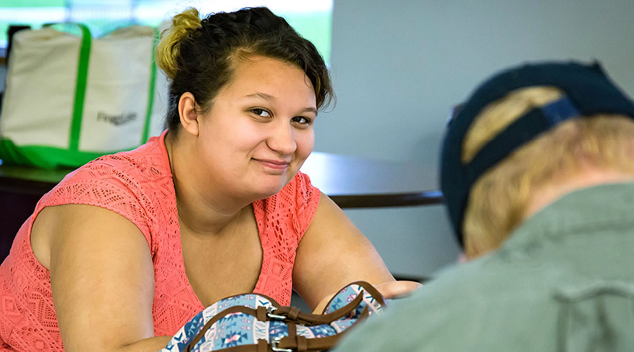 Student using the Newark Campus Center lounge