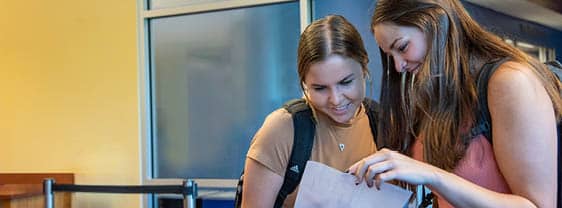 Two FLCC students reviewing course information together.