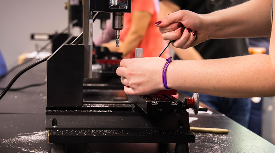 Student setting up a part on the small bench type vertical milling machine