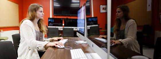 A student working at a computer in a lab