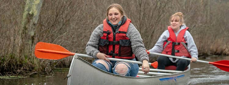 Two community members conoeing on Honeoye Lake.