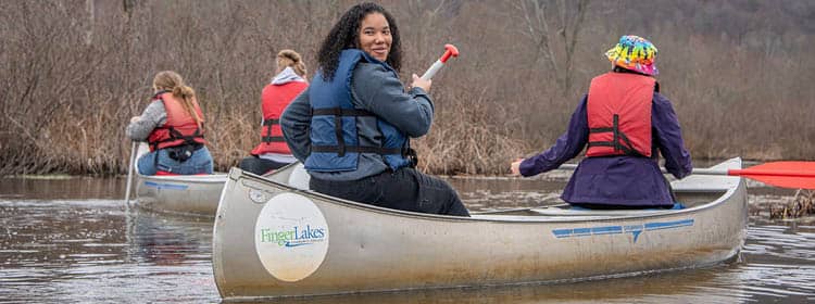 A group of natural resource conservation students in canoes on Honeoye Lake.