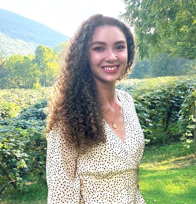 FLCC Nutrition and Dietetics student posing for a photo in front of a vineyard in midsummer.